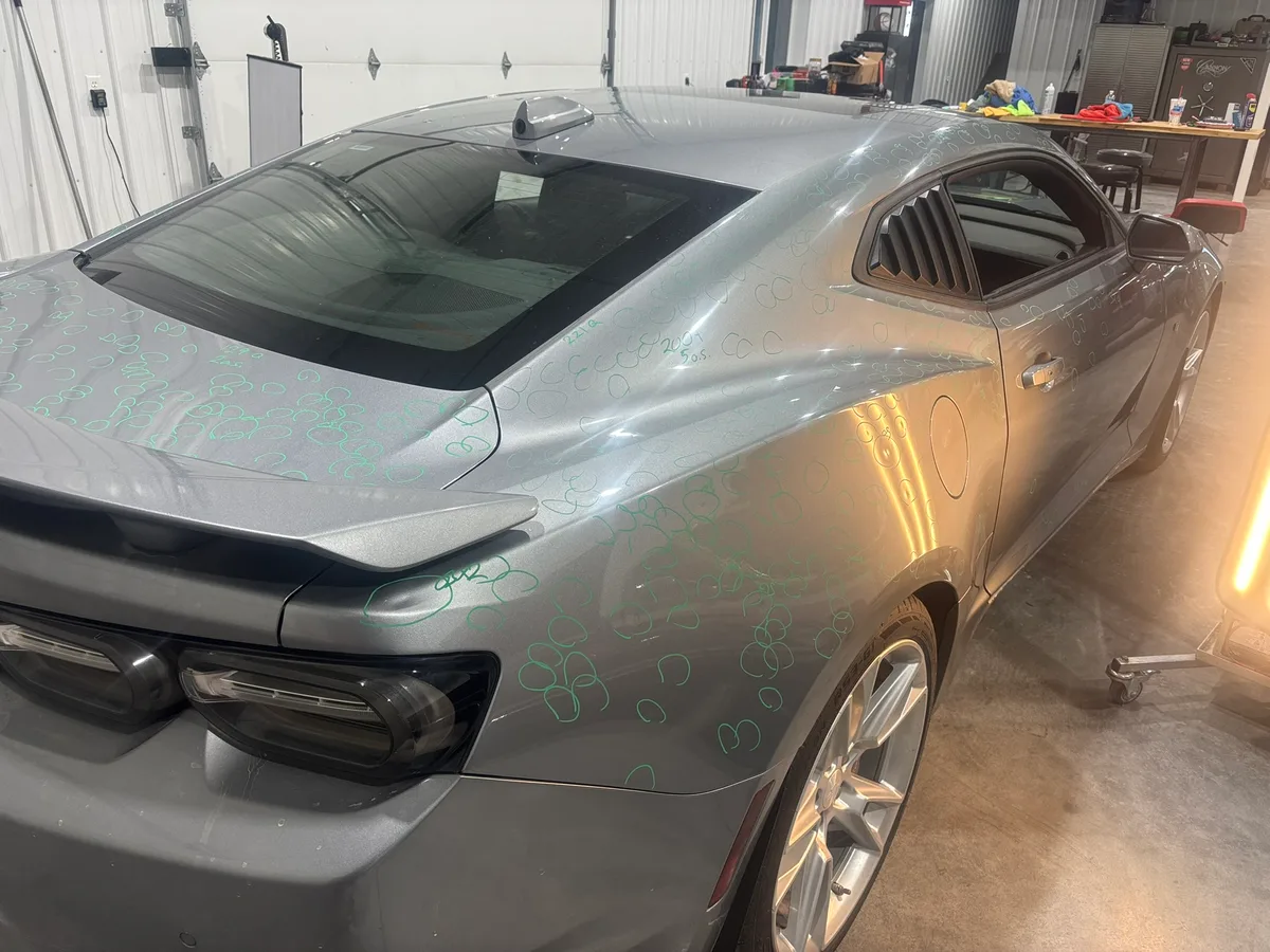Hail-dented roof panel mapped for paintless dent repair at the Hail Solutions Olathe shop
