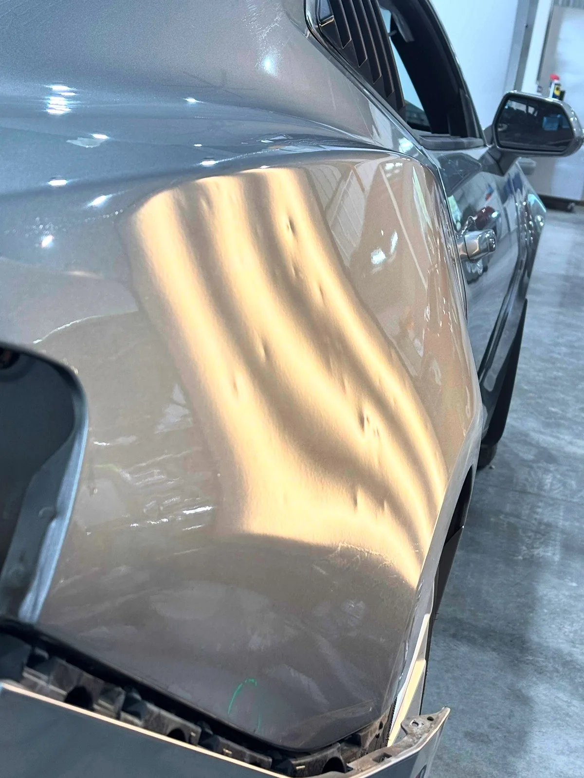 Aluminum panel mapped under LED line-board inspection before heat-assisted paintless dent repair at the Olathe shop